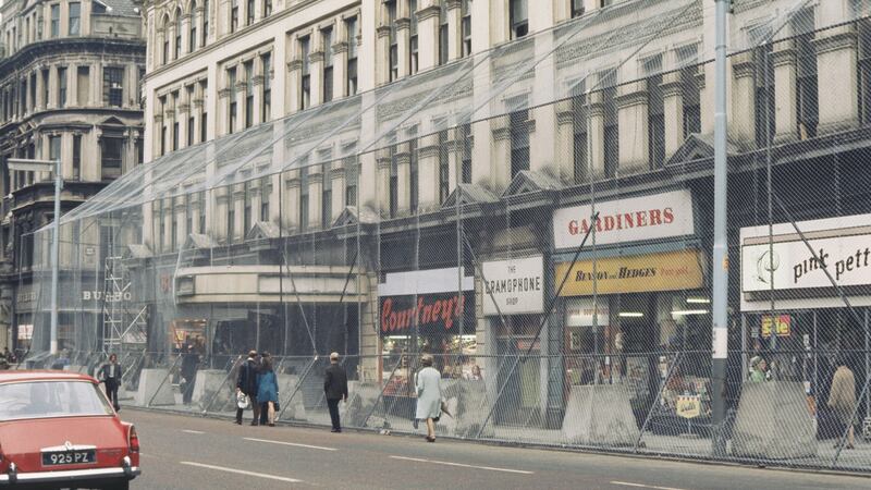 A wire security cage surrounds shops and businesses in the centre of Belfast in 1972  to protect  from possible bomb damage. Photograph: Rolls Press/Popperfoto/Getty Images
