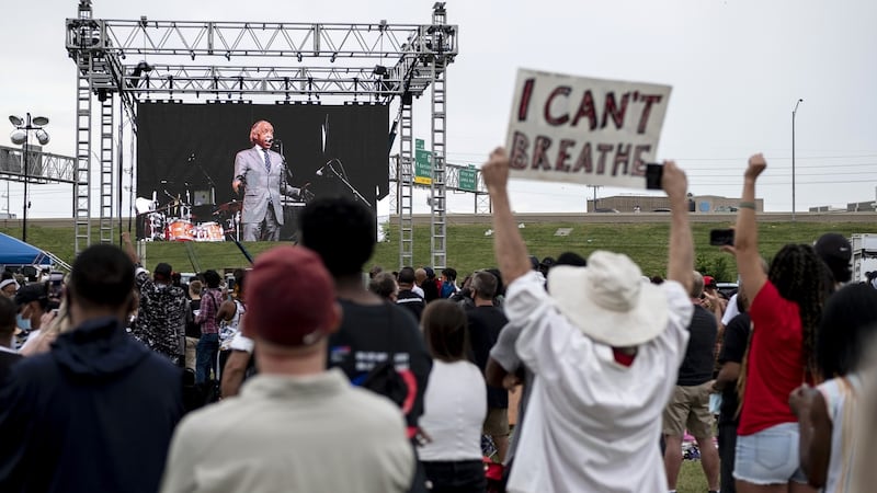 A person holds a sign reading ‘I Can’t Breathe’ as Reverend Al Sharpton speaks on stage. Photograph: Matthew Hatcher/Bloomberg