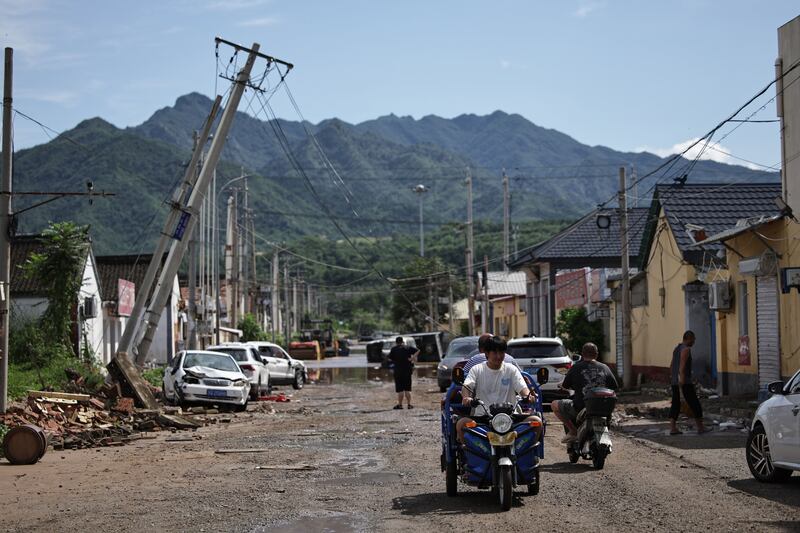 A street affected by flooding at Taishitun, Beijing. Photograph: Andres Martinez Casares/EPA