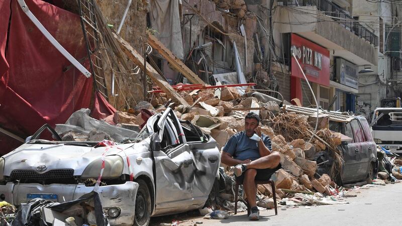 On the phone amid the rubble of a destroyed traditional building in the Gemmayzeh neighbourhood in Beirut. Photograph: Getty