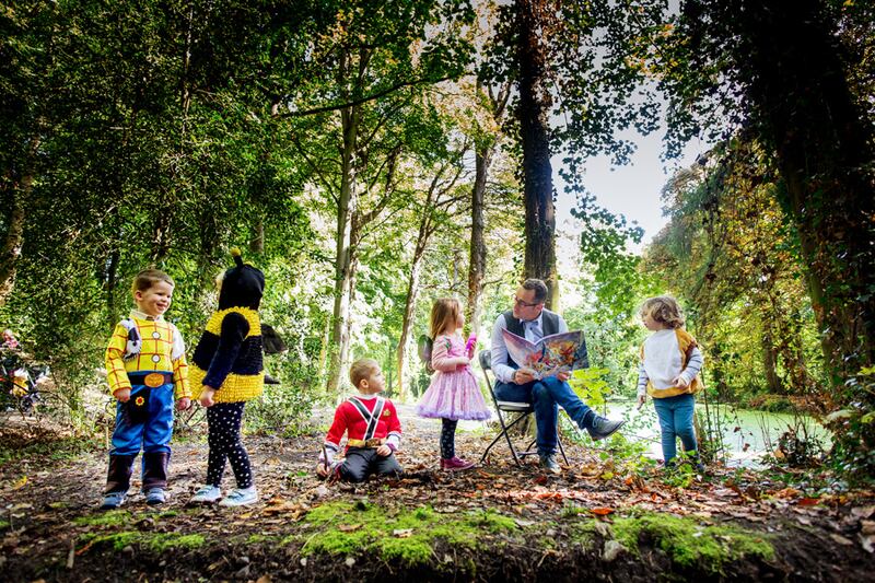 Benji reading Adam Saves the Seasons with Little Smarties