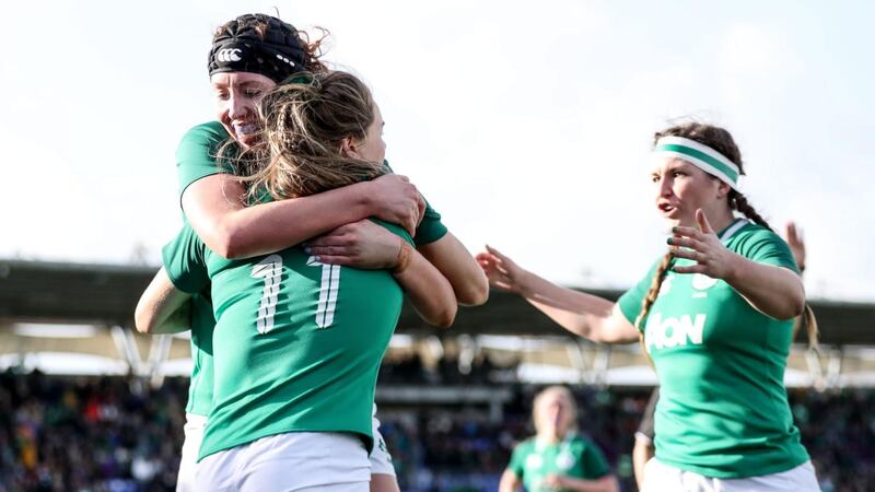 Beibhinn Parsons celebrates with Aoife McDermott and Anna Caplice after scoring Ireland’s opening try against Wales. Photograph: Dan Sheridan/Inpho