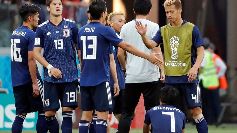 Japan players after their 1-0 defeat to Poland, which saw them progress into the knockout stages. Photograph: Jorge Silva/Reuters