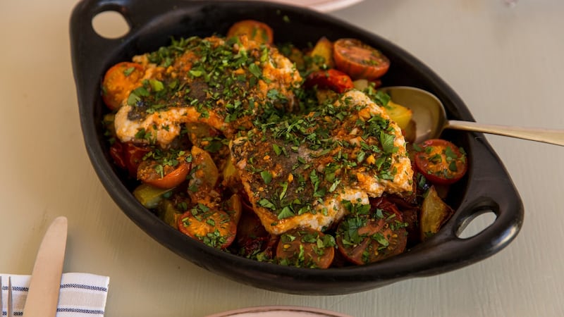 Oven roasted fish with potatoes and tomatoes. Photograph: Emma Jervis