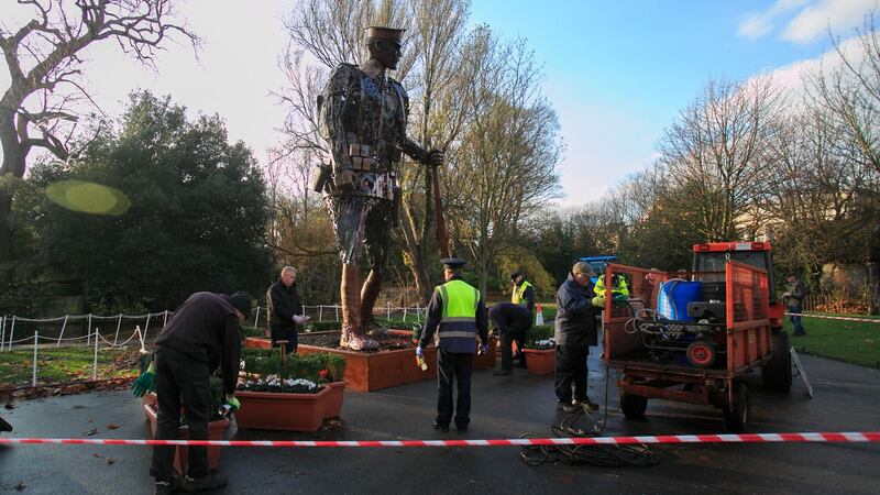 Workmen cleaning the Haunting Soldier which was vandalised in St Stephens Green, Dublin. Photograph: Gareth Chaney/Collins