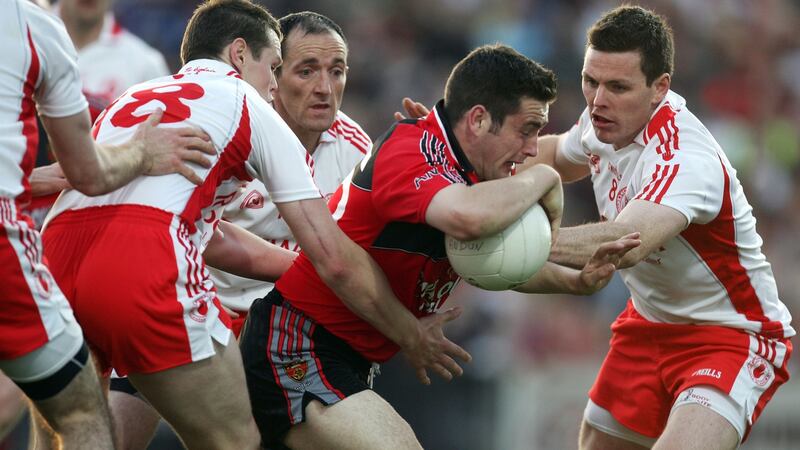 Tyrone’s Peter Donnelly, Brian Dooher and Conor Gormley tackling  Kevin McKernan of Down.  Photograph: INPHO/James Crombie