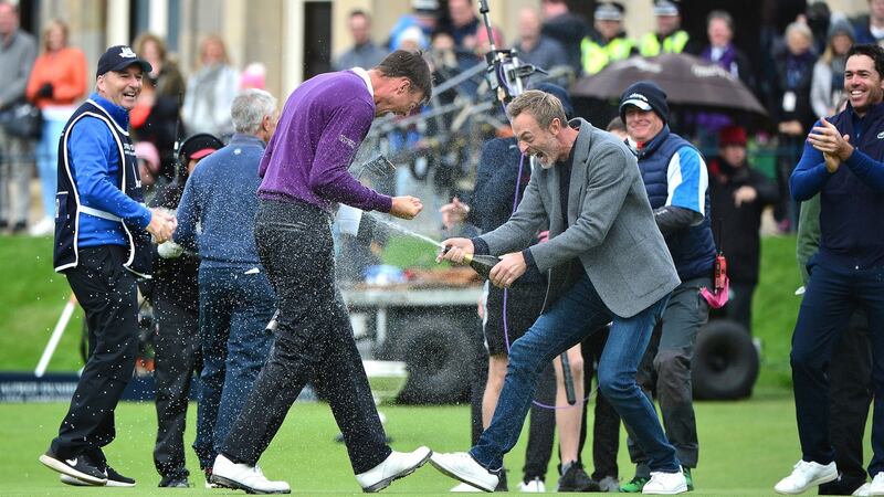 Victor Perez of France is sprayed with a bottle of champagne by Raphael Jacquelin following his victory at the Alfred Dunhill Links Championship at The Old Course. Photo: Mark Runnacles/Getty Images