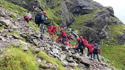 The team lowers a stretcher on 200 metre cables. It takes three abseils to get to the valley floor