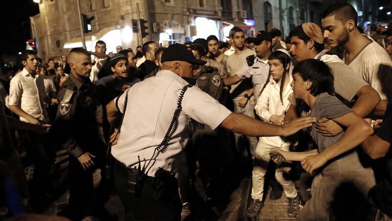 Israeli police stop Israeli far-right supporters during a demonstration in  Jerusalem, on Saturday. A  Palestinian armed with a  gun and a knife is reported to have killed two people and wounded two others, including a child, before being shot dead by police.  Photograph: AFP