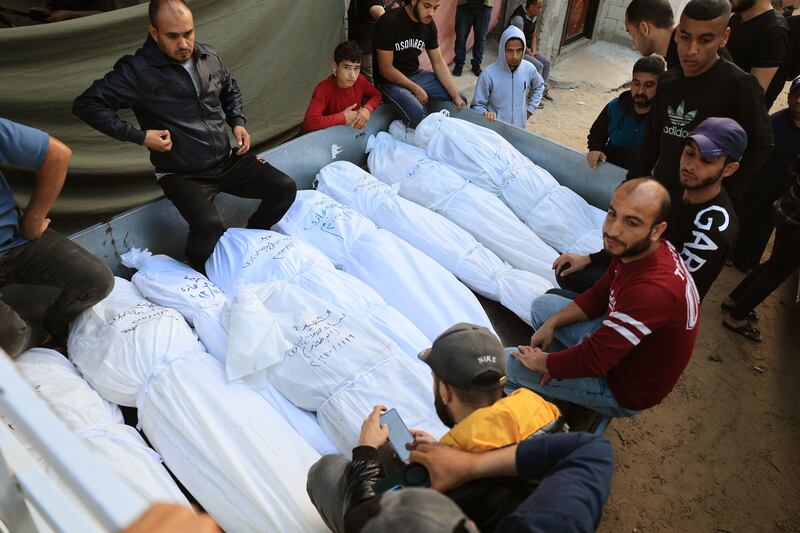 Members of the Hijazi family, killed after their home was hit during an Israeli bombardment at dusk on November 9th, are placed in the back of a pick-up truck to be taken for burial from the Najjar hospital in Rafah in the southern Gaza Strip. Photograph: Said Khatib/AFP via Getty Images