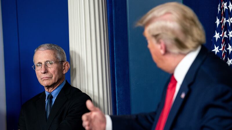 Dr Anthony Fauci listens as President Donald Trump speaks in a coronavirus White House briefing on March 26th. Photograph: Erin Schaff/The New York Times