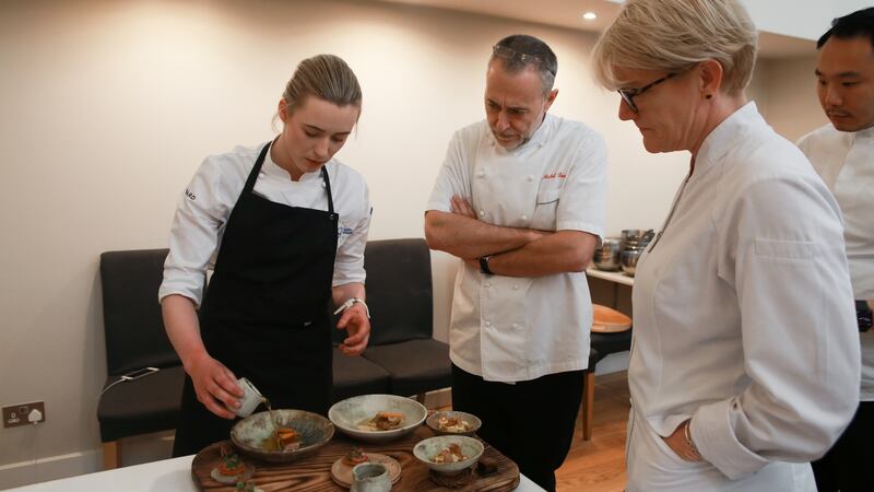 Euro-Toques Ireland young chef winner Gráinne Mullins presenting her dishes to judges Michel Roux junior (centre) and Margot Janse.