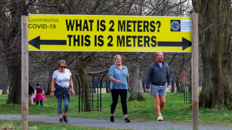 A sign notifies people of the 2m social distancing measures as people exercise in Phoenix Park. Photograph: Paul Faith/AFP via Getty