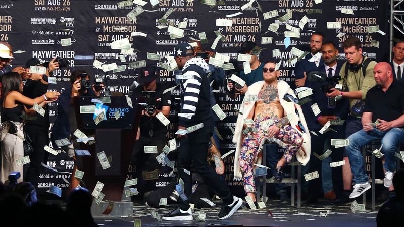 Mayweather showers McGregor with money. Photo: Mike Stobe/Getty Images
