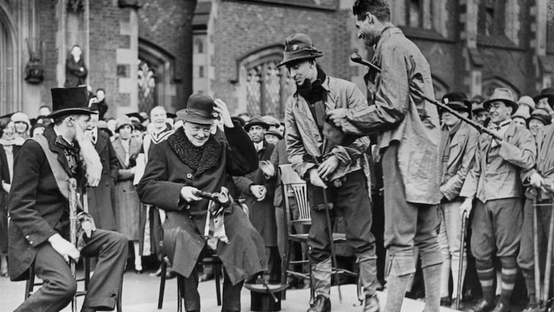 Churchill is presented with a green hat and clay pipe during rag week at Queen’s University Belfast in 1926. Photo: Topical Press Agency/Getty Images
