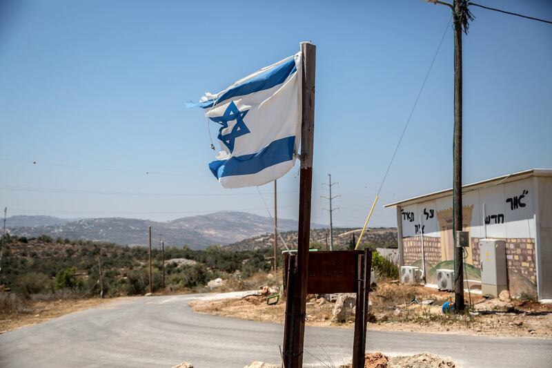 An Israeli flag flies at the entrance to the Evyatar outpost in the occupied West Bank. Photograph: Sally Hayden