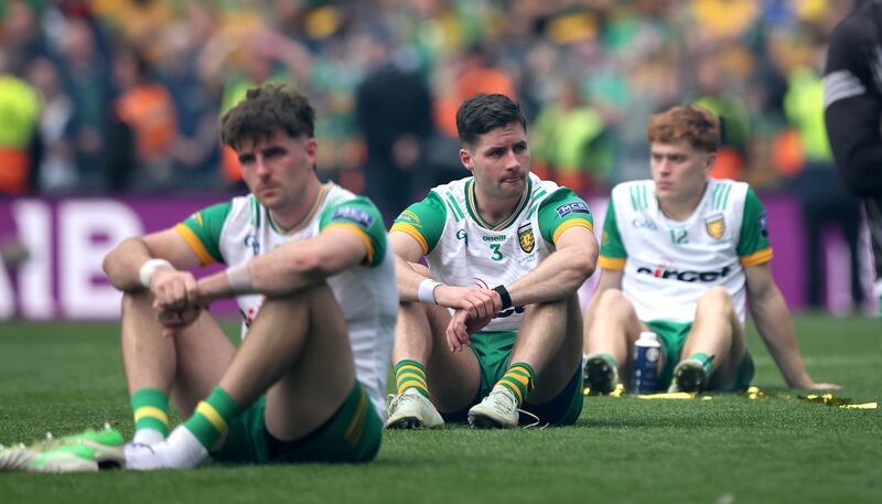 Donegal players sit dejected after the trophy presentation. Photograph: Ryan Byrne/Inpho