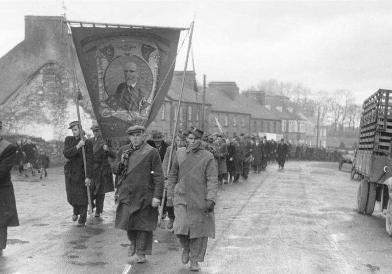 February 21st ,1948: Citizens of Ballaghadereen, Co Mayo, marching out to meet de Valera. They are carrying a banner of the 19th-century Land-Leaguer, Michael Davitt. Photo by Bert Hardy/Picture Post/Hulton Archive/Getty Images