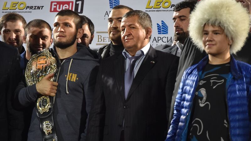 Khabib holds his champions belt next to his father Abdulmanap (c) upon arrival at the Anzhi-arena stadium in Makhachkala. Photo: Vasily Maximov/Reuters