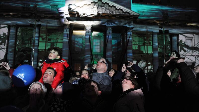 Spectators watching the performance at The Customs House at the NYF Dublin on New Year’s Eve. Photograph: Aidan Crawley
