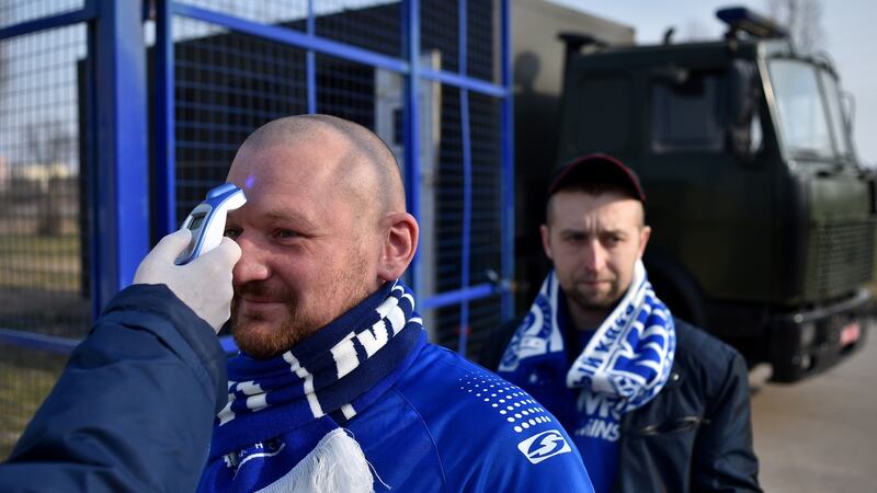 A fan’s temperature is checked entering the stadium for FC Minsk v FC Dinamo-Minsk in Belarus. The Belarusian League is the only league in Europe to continue during the pandemic. Photograph: Sergei Gapon/Getty Images