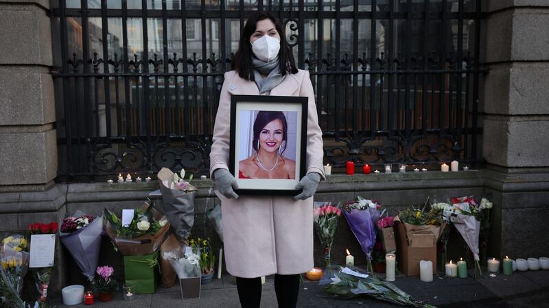 Vicky Masterson holds a picture of Ashling Murphy at a vigil held outside Leinster House. Photograph: Laura Hutton/The Irish Times