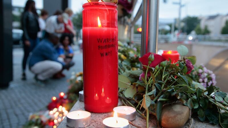 People mourn near the crime scene in Munich. Photograph: Johannes Simon/Getty Images