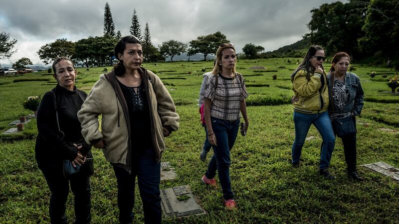 Aura Pérez (left), aunt of Óscar Pérez, who claimed his body from the morgue, walks to his grave in El Hatillo, Venezuela on Sunday. Photograph: Meridith Kohut/The New York Times