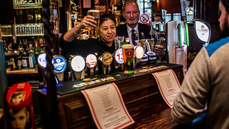 Staff and a customer are pictured in the Long Stone on Townsend Street in Dublin on Friday. Photograph: James Forde/The  Irish Times.