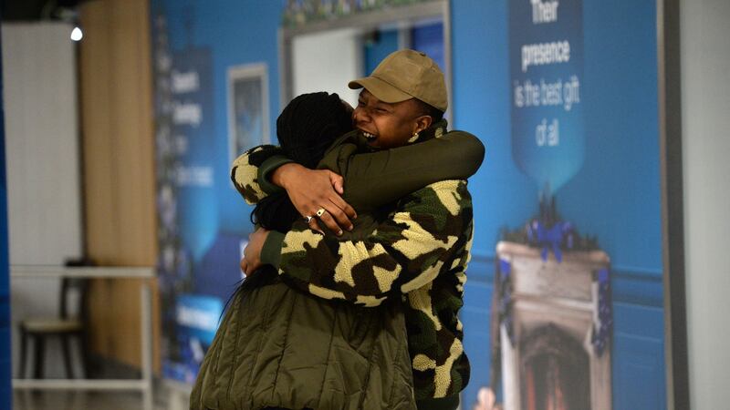 Jacob Maimela greets his sister Vivien Nyathi arriving at Dublin airport  from South Africa with her family. Photograph: Dara Mac Dónaill