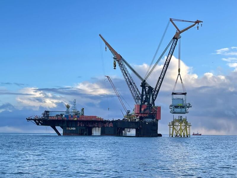 The Balder, one of the largest vessels of its type in the world, is shown lifting one of two 1,200 tonne substation platforms onto its foundation at the Neart na Gaoithe offshore wind farm off the east coast of Scotland