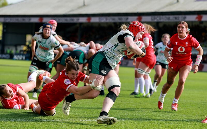 Aoife Wafer on her way to scoring a try despite the efforts of Wales player Kate Williams in the Women's Six Nations round four game at Newport in April. Photograph: Dan Sheridan/INPHO
