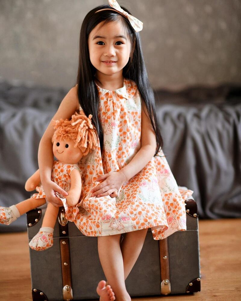 Orange print dress by LinzyO €38-€43 at Kid, Powerscourt Centre, doll €30.