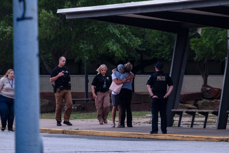 People embrace outside Memorial High School after a shooting at the Natalie Medical Buidling in Tulsa, Oklahoma on Wednesday. Photograph: Joseph Rushmore/The New York Times