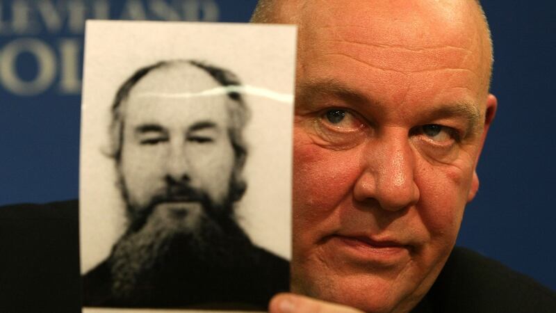 Detective Superintendent Tony Hutchinson holds the fake passport picture of John Darwin, the canoeist who turned up after being presumed dead in 2002. Photograph: Christopher Furlong/Getty Images