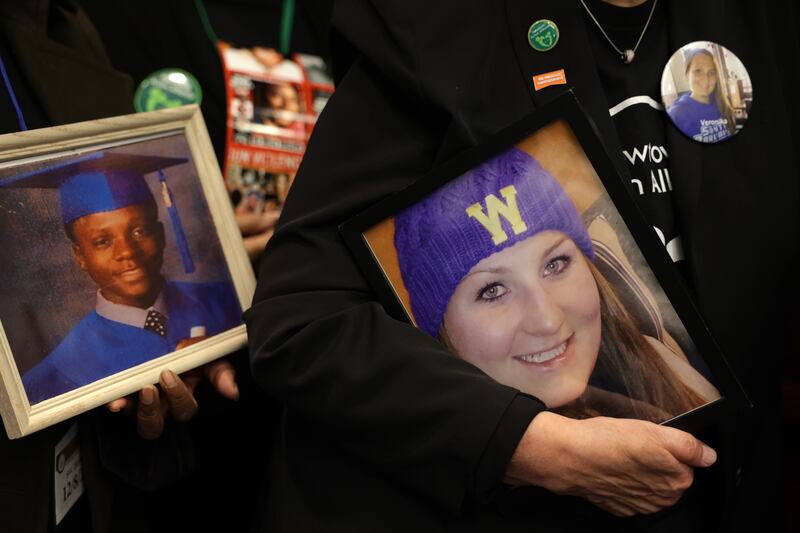 Family members hold pictures of victims during an event to mark the 10th anniversary of the shooting. Photograph: Alex Wong/Getty Images