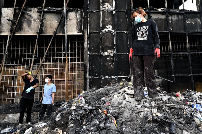 Local residents clean up the rubble of a damaged supermarket after it was set ablaze during protests in Kathmandu. Photograph: Pedro Pardo/AFP via Getty Images         
