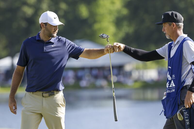 Scottie Scheffler of the US (L) with his caddie Ted Scott (R) on the 14th green. Photograph: Erik S Lesser