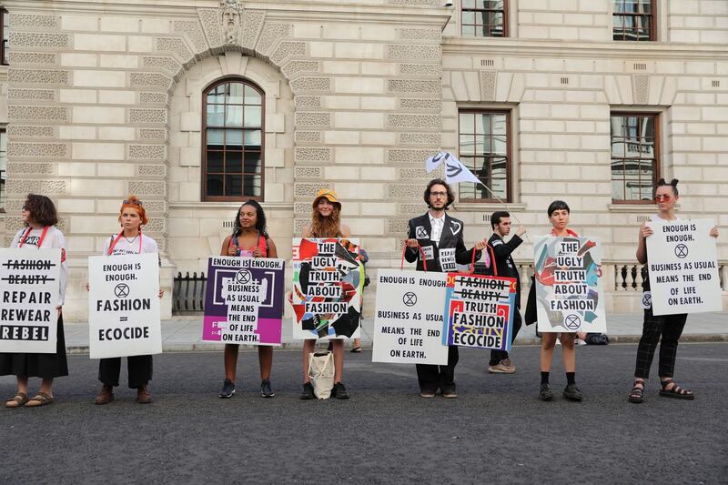 Protesters from Extinction Rebellion demonstrate outside the  Victoria Beckham Spring/Summer 2020  show. Photograph: Isabel Infantes/PA Wire