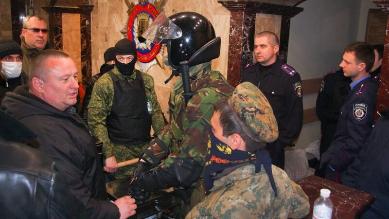 Members of Ukrainian police and pro-Russian protesters stand inside the seized Regional Interior Ministry building in Donetsk, Ukraine, today. Photograph: EPA