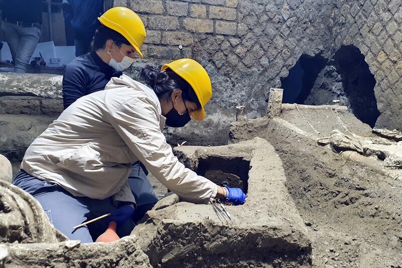 Archeologists excavating a villa amid the ruins of the 79AD volcanic eruption in Pompeii