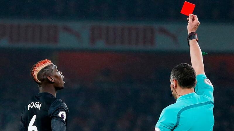 Referee Andre Marriner shows a red card to Manchester United’s French midfielder Paul Pogba . Photograph: Getty Images