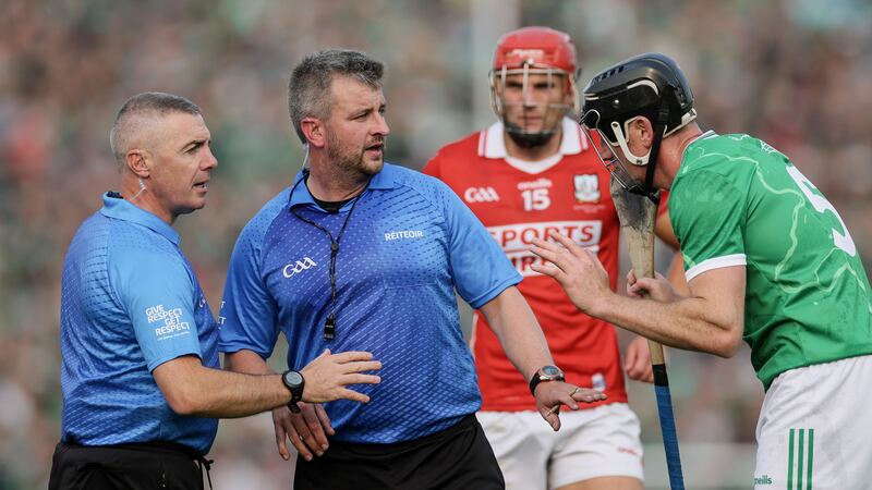 Referee Thomas Walsh (centre) speaks with Limerick's Diarmaid Byrnes. Photograph: Laszlo Geczo/Inpho
