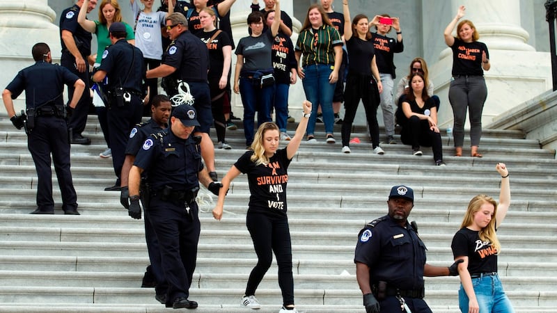 Demonstrators are arrested on the steps of the US Capitol as they protest against the appointment of supreme court nominee Brett Kavanaugh in Washington, DC, US. Photograph: Jose Luis Magana/AFP/Getty Images