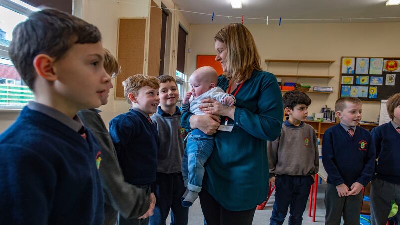 Parent Lisa Crowley and 6-month-old Dave,  and students in Scoil na mBuachaillí, Clonakilty, taking part in the Roots of Empathy programme. Photograph: Michael Mac Sweeney/Provision