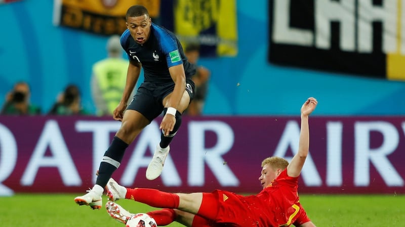Kylian Mbappe skips past Kevin De Bruyne. Photo: Lee Smith/Reuters