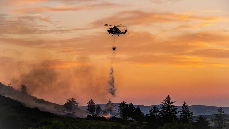An Air Corps helicopter drops water on a gorse fire in Co Donegal. Photograph: Air Corps/Facebook
