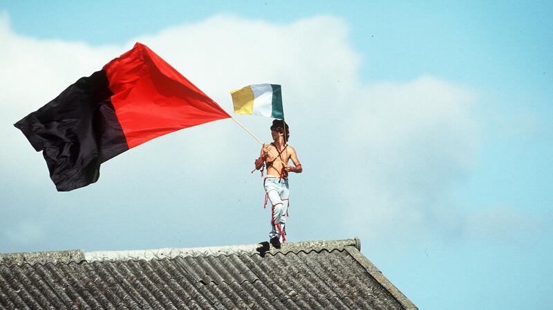A Down fan finds a unique vantage point on top of a stand at Croke Park during the 1991 All-Ireland final. Photograph:James Meehan/Inpho