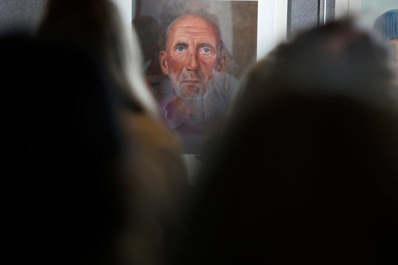 Attendees take in the detail of Layla's portrait of her grandfather Ger. Photograph: Nick Bradshaw / The Irish Times