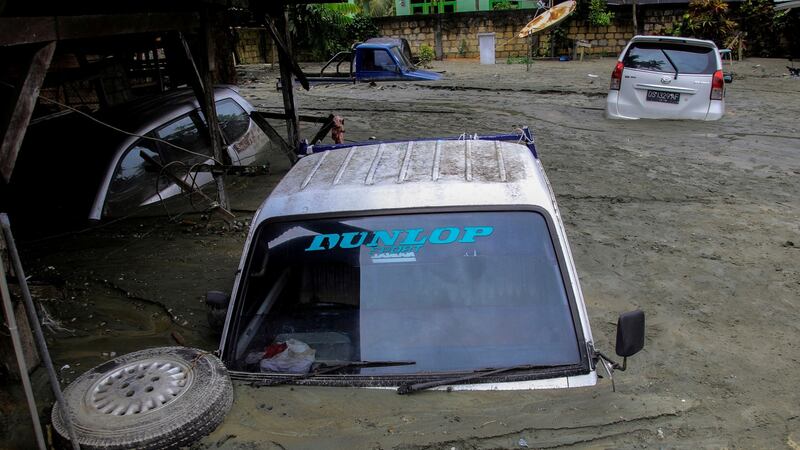 Cars are submerged in mud following a flash flood in Sentani, Papua, Indonesia. Photograph: Antara Foto/Reuters